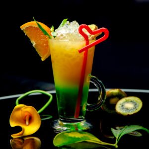 a glass of kiwifruit and orange cocktail garnished with orange and kiwifruit slice