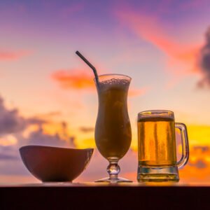 A glass of beer with Beautiful tropical Maldives island