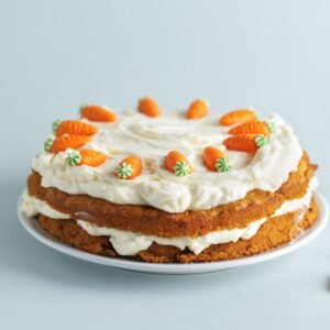 Easter carrot cake with frosting on blue background